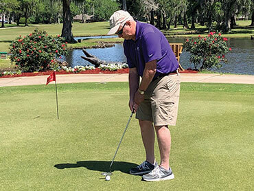 Joseph Bergeron lines up a putt after successful stroke rehab and recovery.